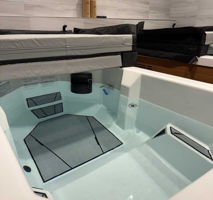 Walk-in bathtub partially filled with water and seat