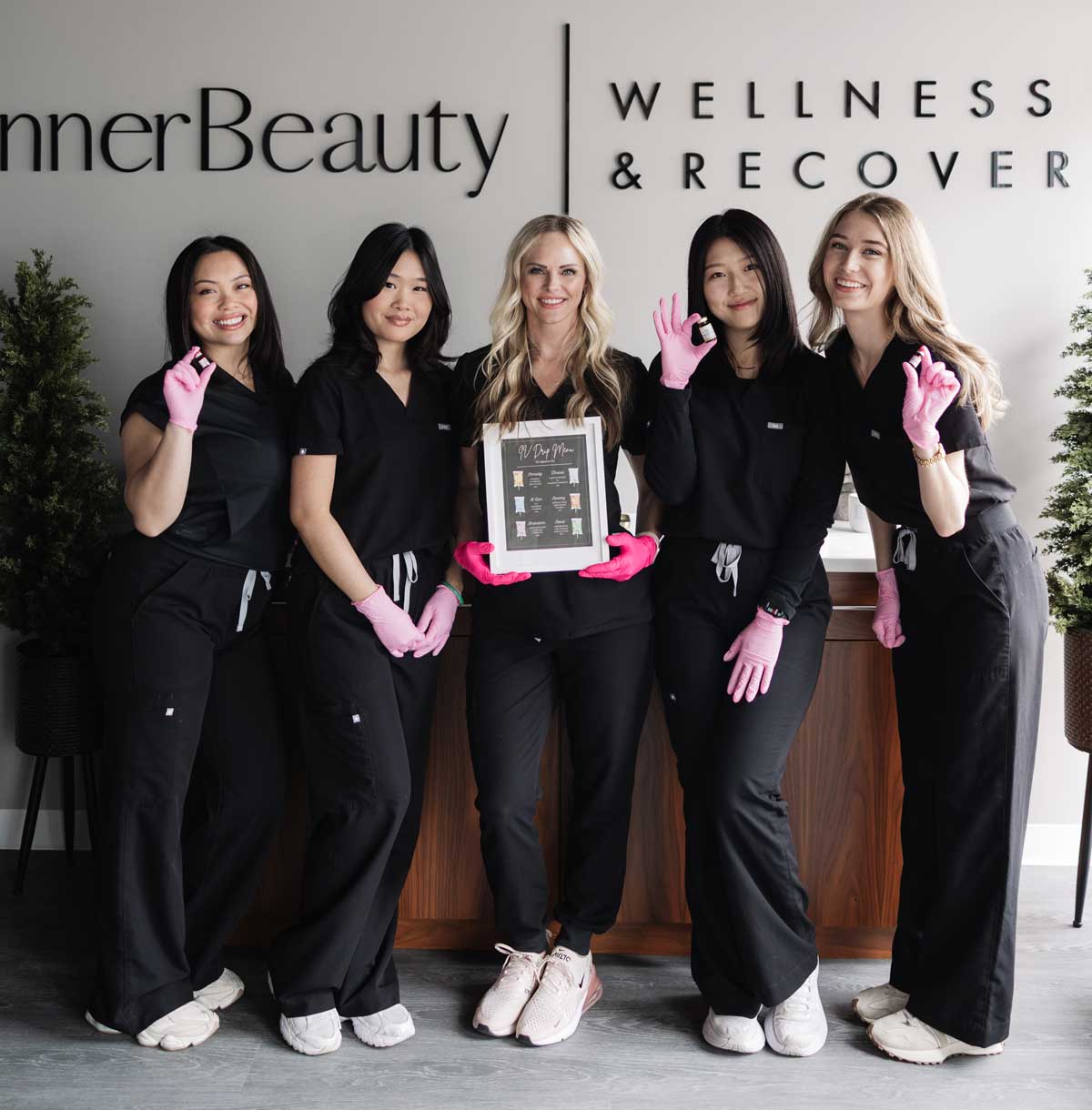 innerbeauty-wellness-staff Five clinic staff in scrubs at wellness center